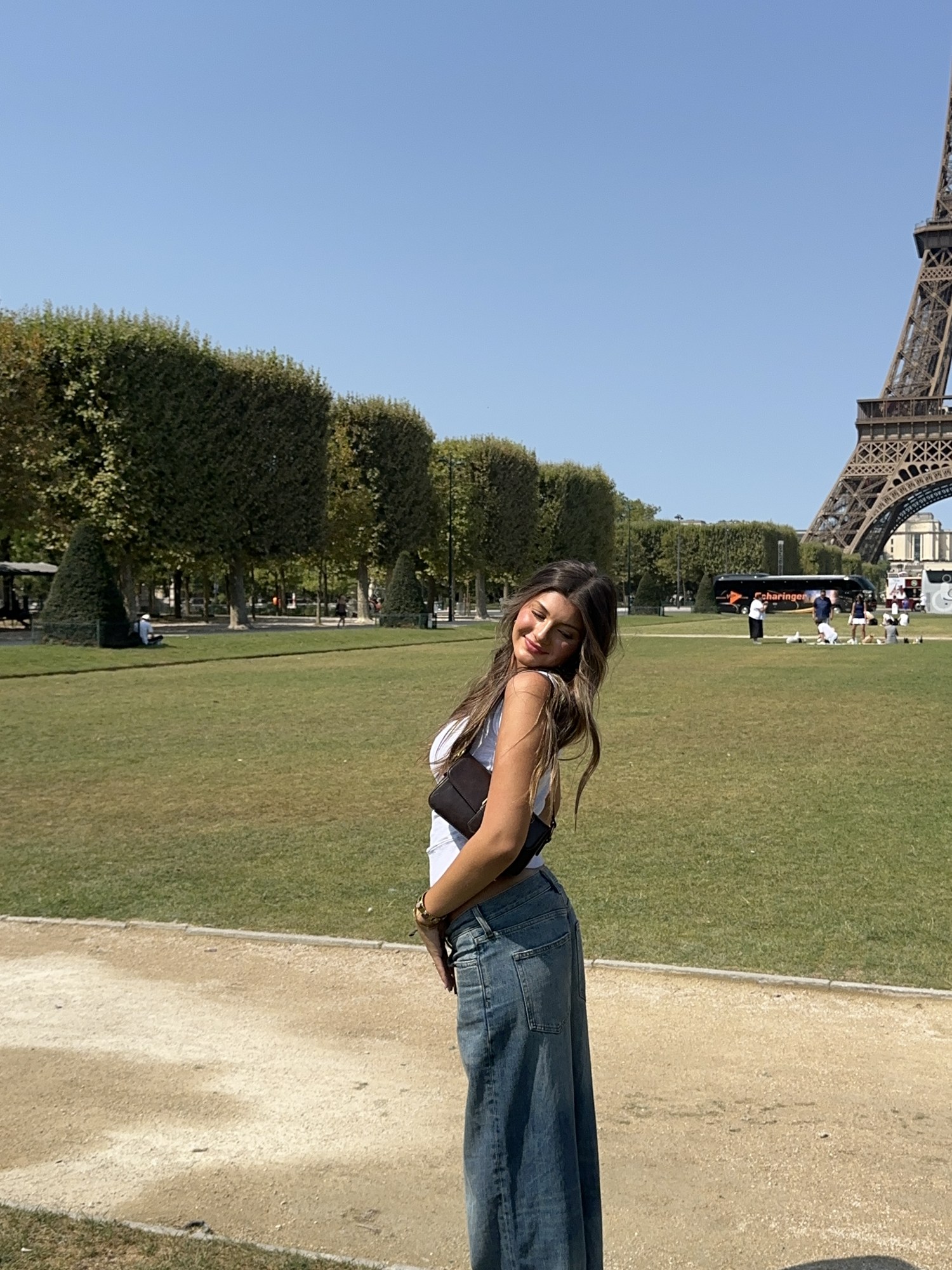 Breck looking back and smiling while visiting the lawns near the Eiffel Tower in Paris.